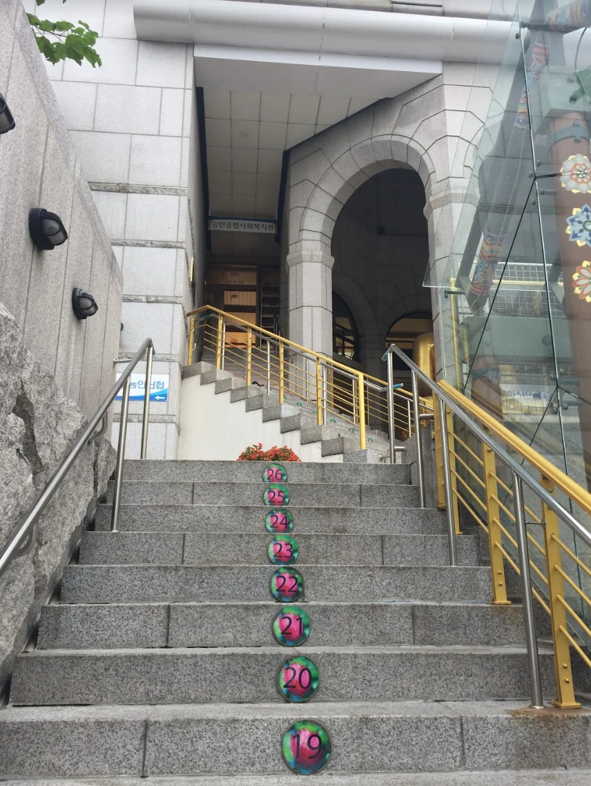 The staircase with numbered steps leading up to the Buddhist welfare center in Seoul, South Korea, where the coffin therapy takes place
