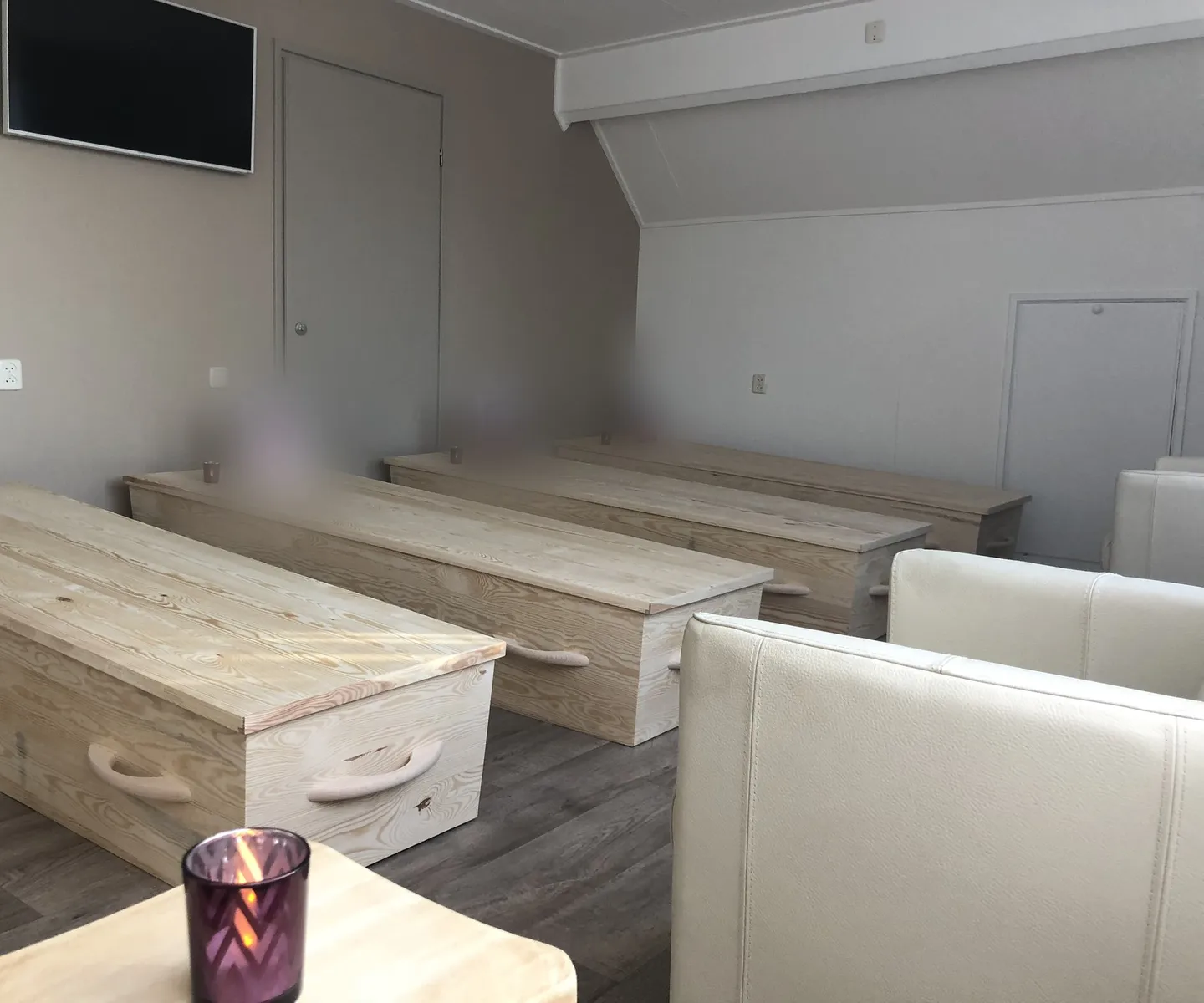 Memento mori in practice: the coffin meditation seminar room in May 2018, with wooden coffins, each with a portrait and a candle